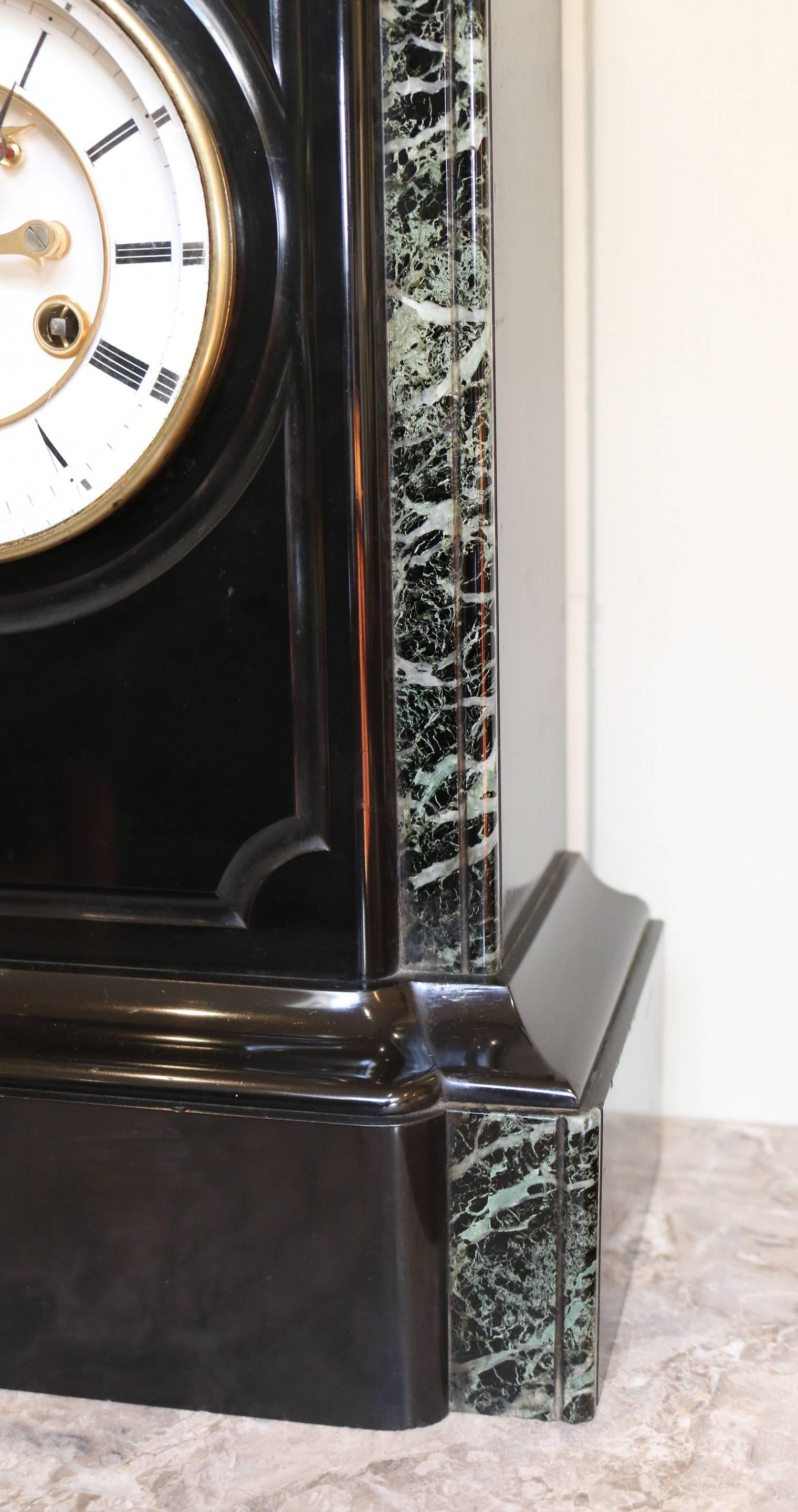 A good example of a high quality polished Belgium slate bell striking mantel clock with a visible Brocot escapement. The rectangular case has grey variegated marble sides and an engraved molding front. It has a thick bevel edge glass in a brass