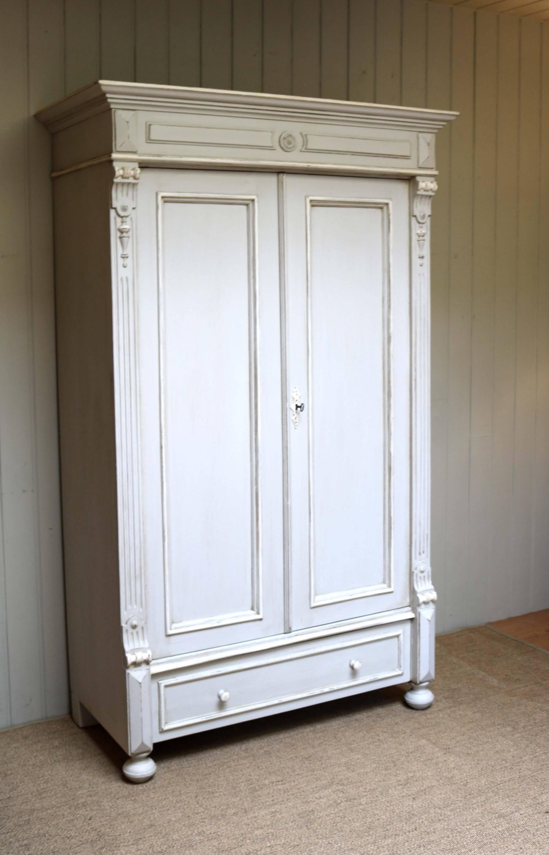 Continental painted pine two-door wardrobe having panelled doors with reeded side pilasters and a single base drawer fitted with an internal hanging rail. Measures: The internal depth is 44 cm,
East Europe, circa 1890.