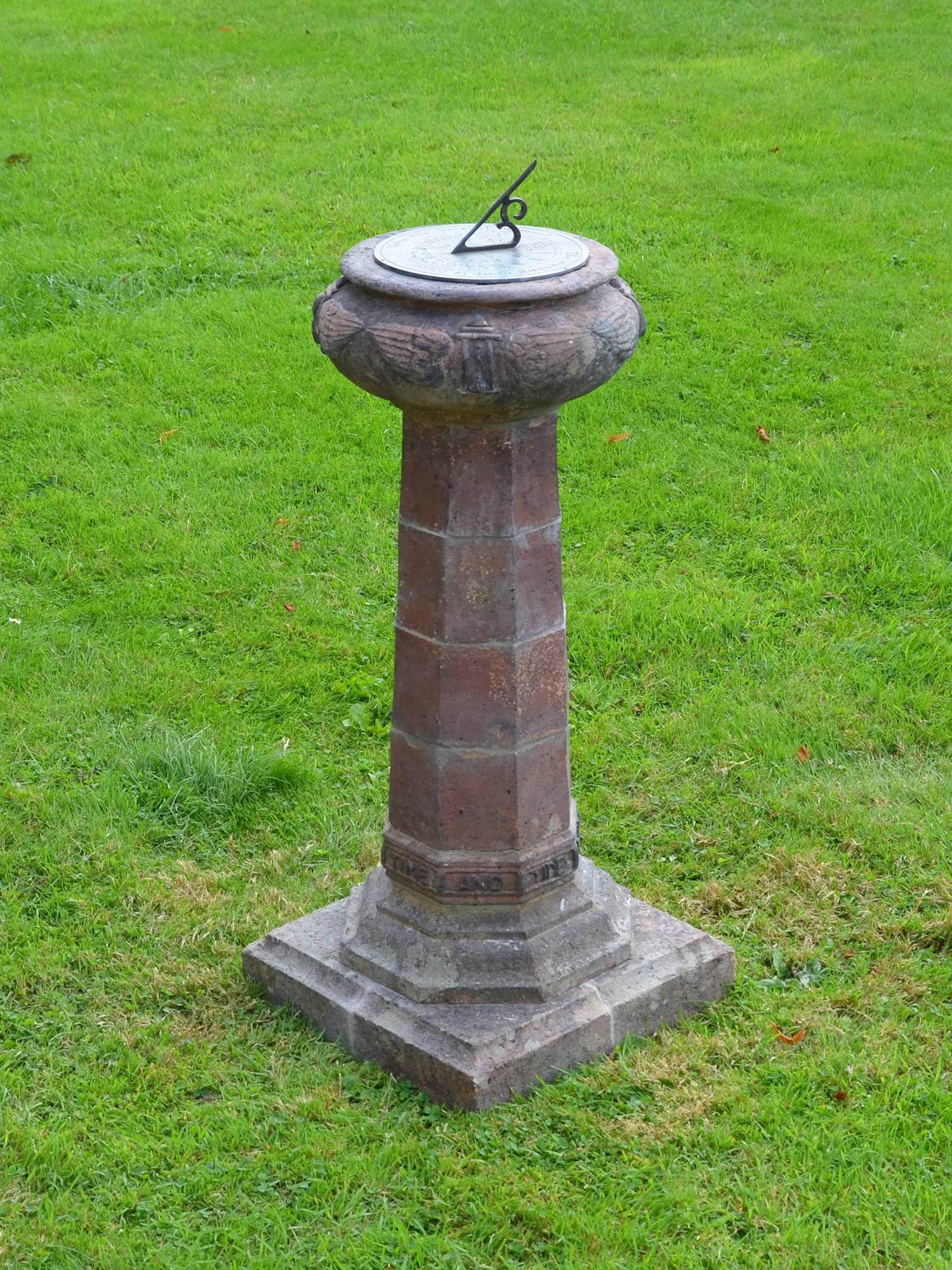 Of pillar form with inscription ‘Time and tide wait for no man,’ The four sectioned column supporting a circular bulbous cap decorated with hour-glass and wing repeated motif, supporting a circular sundial plate.