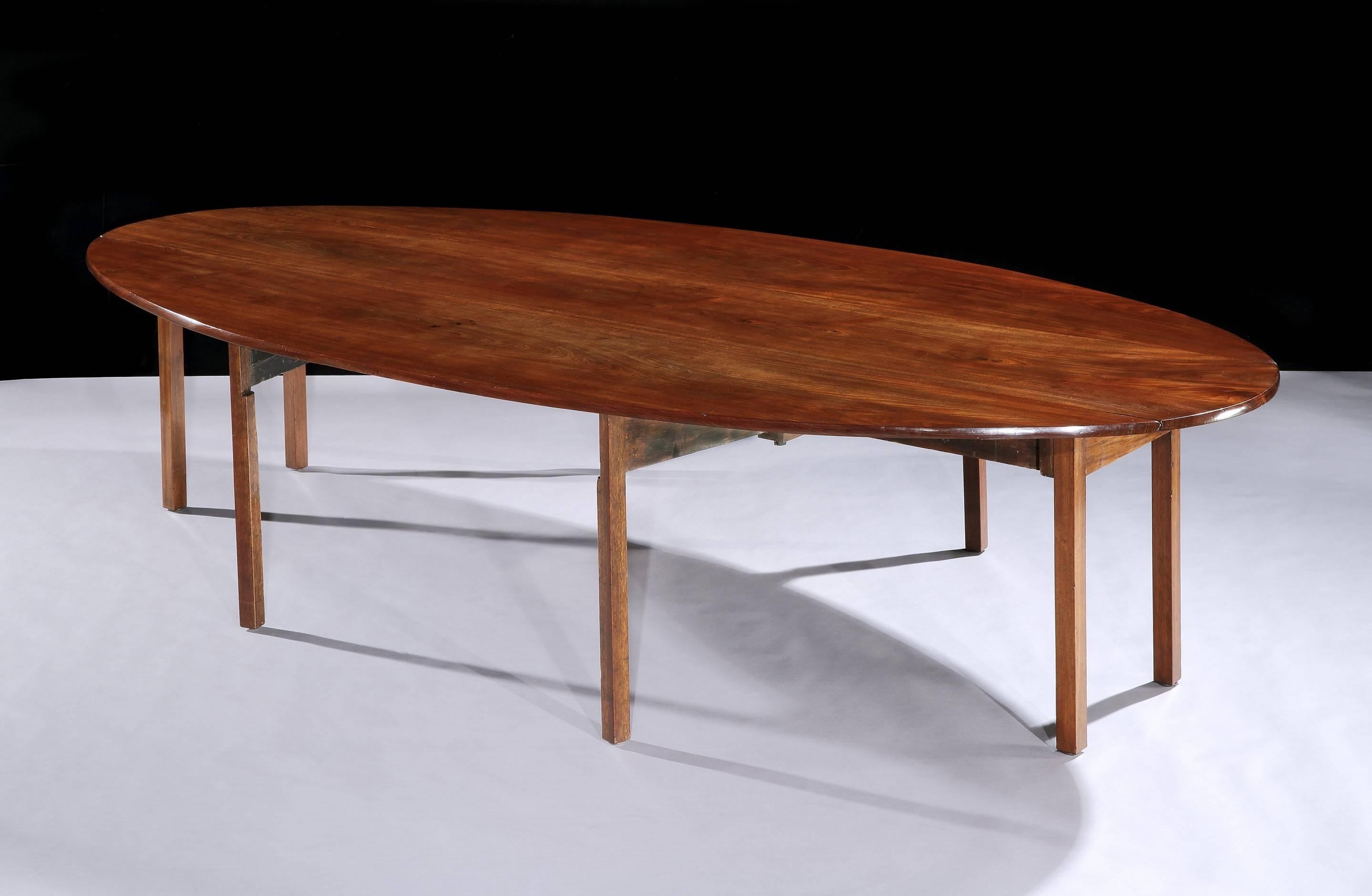 A George III mahogany drop-leaf table of huge proportion.