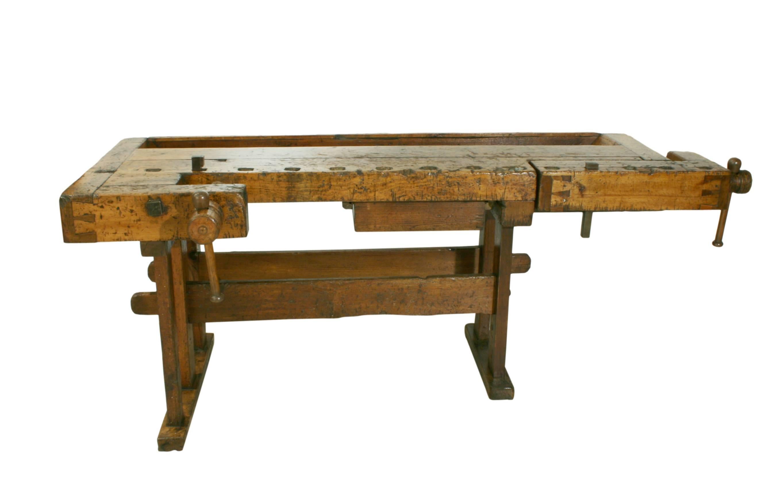 Antique carpenter's workbench. 
A wonderful large workbench with solid beech wood top and pine legs by Otto Mecke, Berlin. The bench has two vices, one on the front edge and the other on the right-hand side. The top leading edge is drilled with