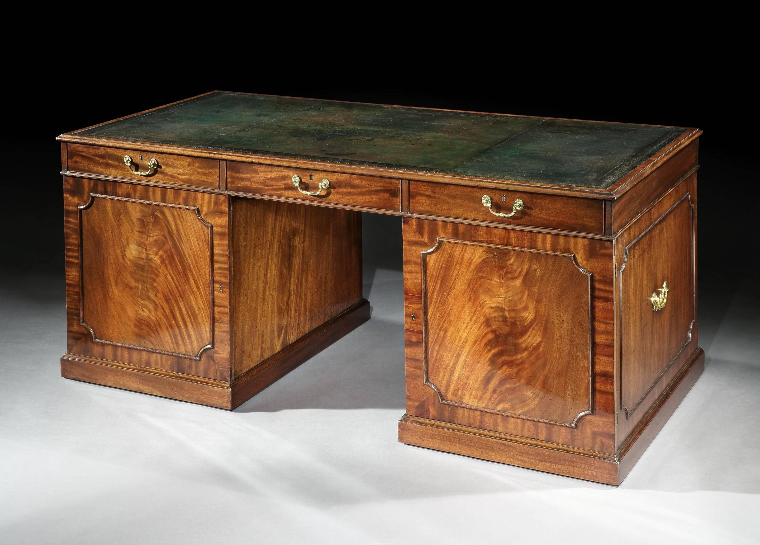 The desk is of very generous proportion fitted with three drawers in the top section and three graduated drawers to each pedestal. The reverse side fitted with a further three graduated drawers each pedestal and concealed behind doors.