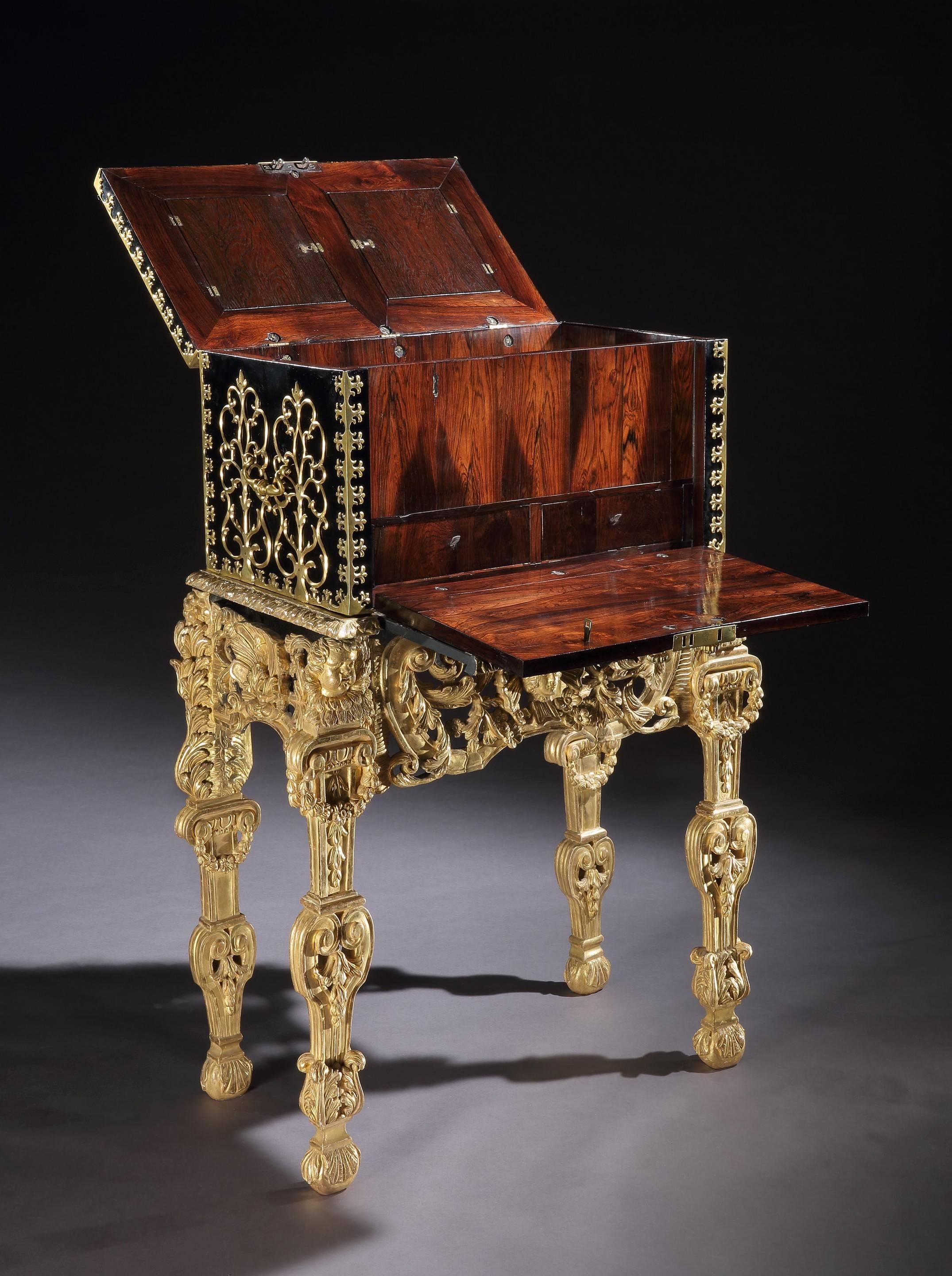 A rare William and Mary brass bound ebonised strong box on giltwood stand. (4409821). 

The stand is original to the strong box and has concealed lopers to the front, which support the fold-down front of the box. The interior of the strong box