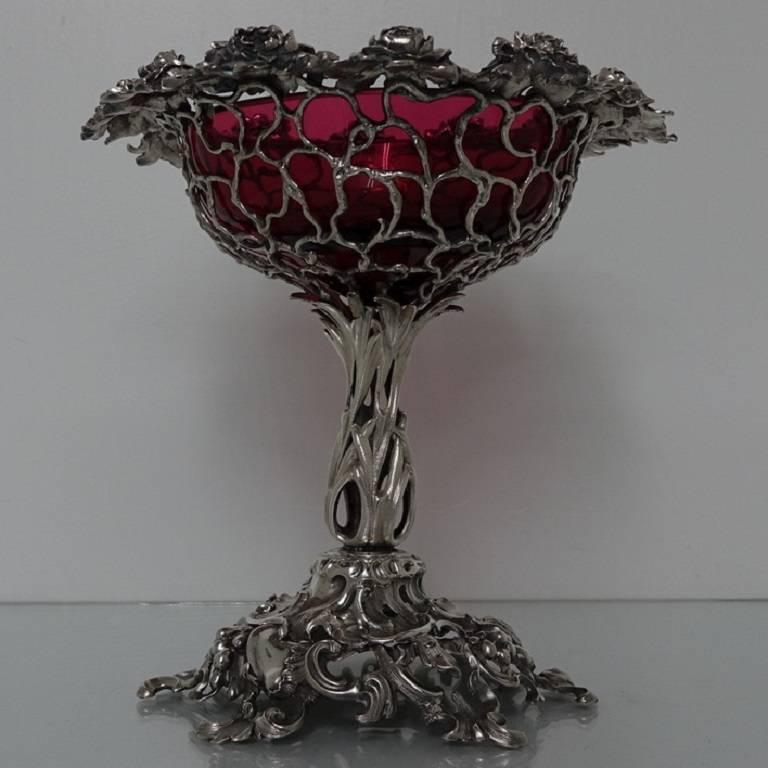 A very fine and ornately designed 19th century cast centrepiece with detachable cranberry glass liner. The bowl of the centrepiece is naturalistically designed with a stunning floral border. The foot and the stem mirrors the craftsmanship of the