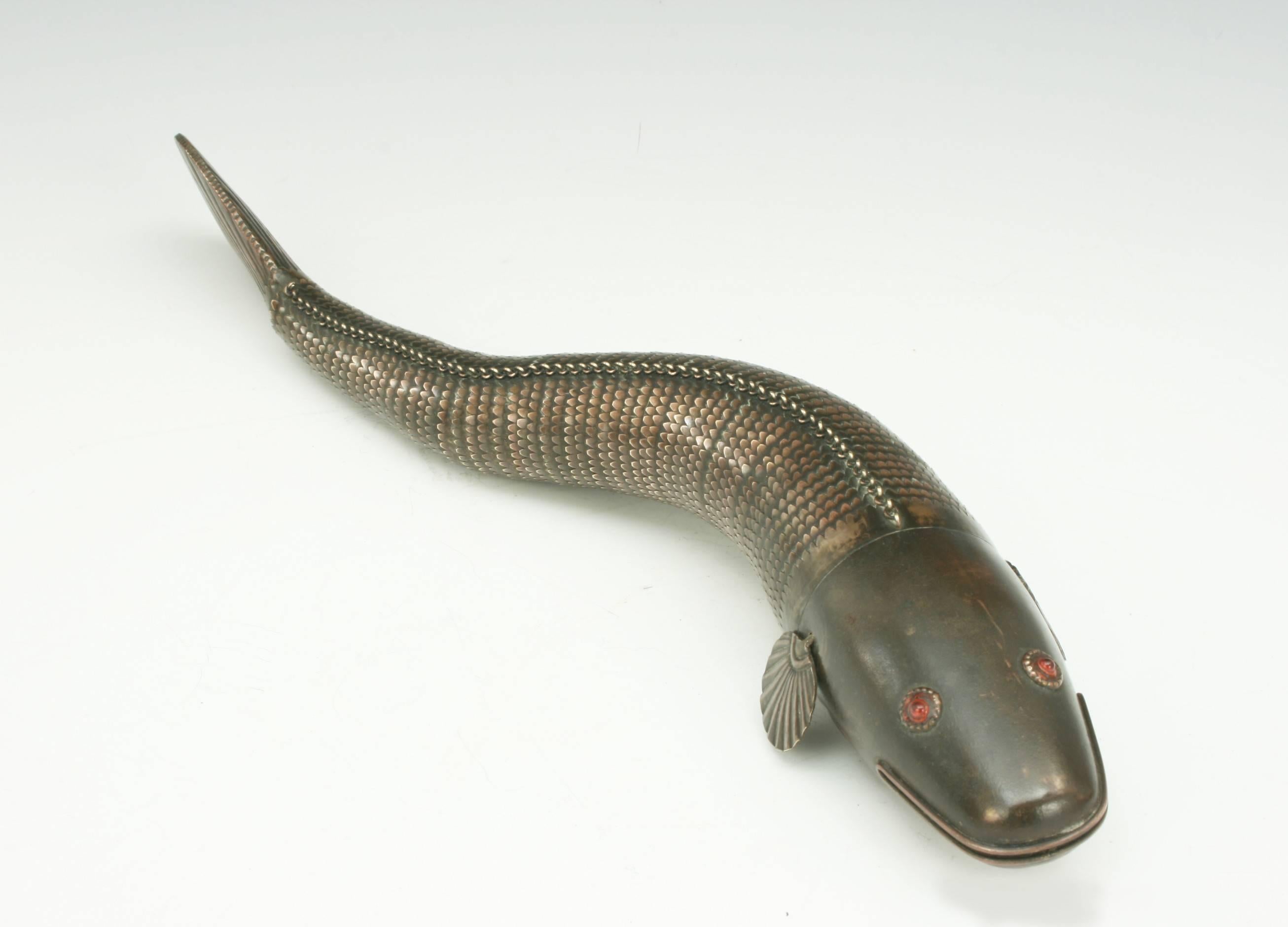 Fishing, Medina style articulated fish. 
A late 19th-early 20th century metal articulated Medina fish. The fish is made of brass with a wonderful patina. The head is with red eyes and fins, connected to an articulated body with a tail fin. The fish