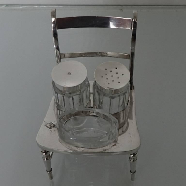 A very rare and stylish silver plated condiment set made in the form of a chair. The cruet has three glass condiments: Salt, pepper and mustard. There is a beautifully struck registration mark on the seat of the chair.