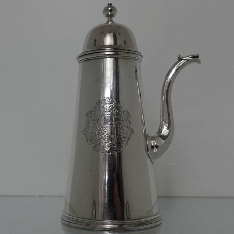 A very rare and extremely beautiful Britannia standard tapering plain formed early 18th century chocolate pot. The body of the chocolate pot has a very noble looking coat of arms for importance. The lid of the pot is hinged with a detachable cover,