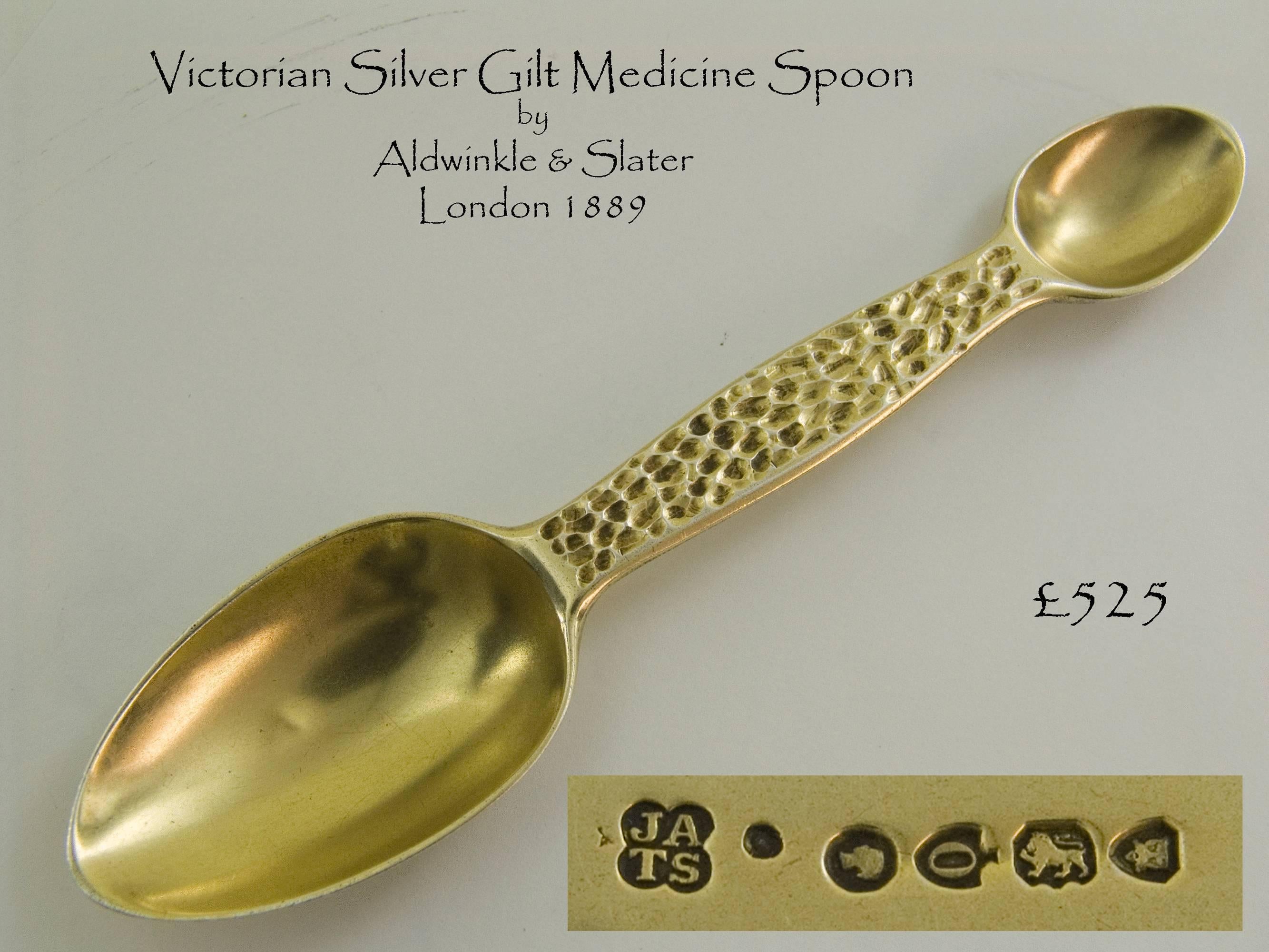 A very good Victorian medicine spoon with original gilding and having a hammered decorative finish to the handle.