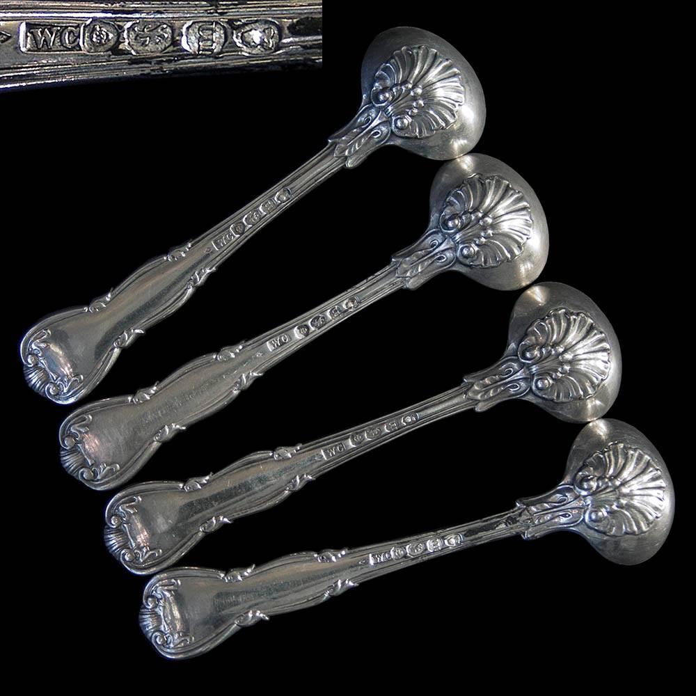 A very good set of four George IV Kings Husk pattern silver salt spoons with gilded bowls and original family crest.