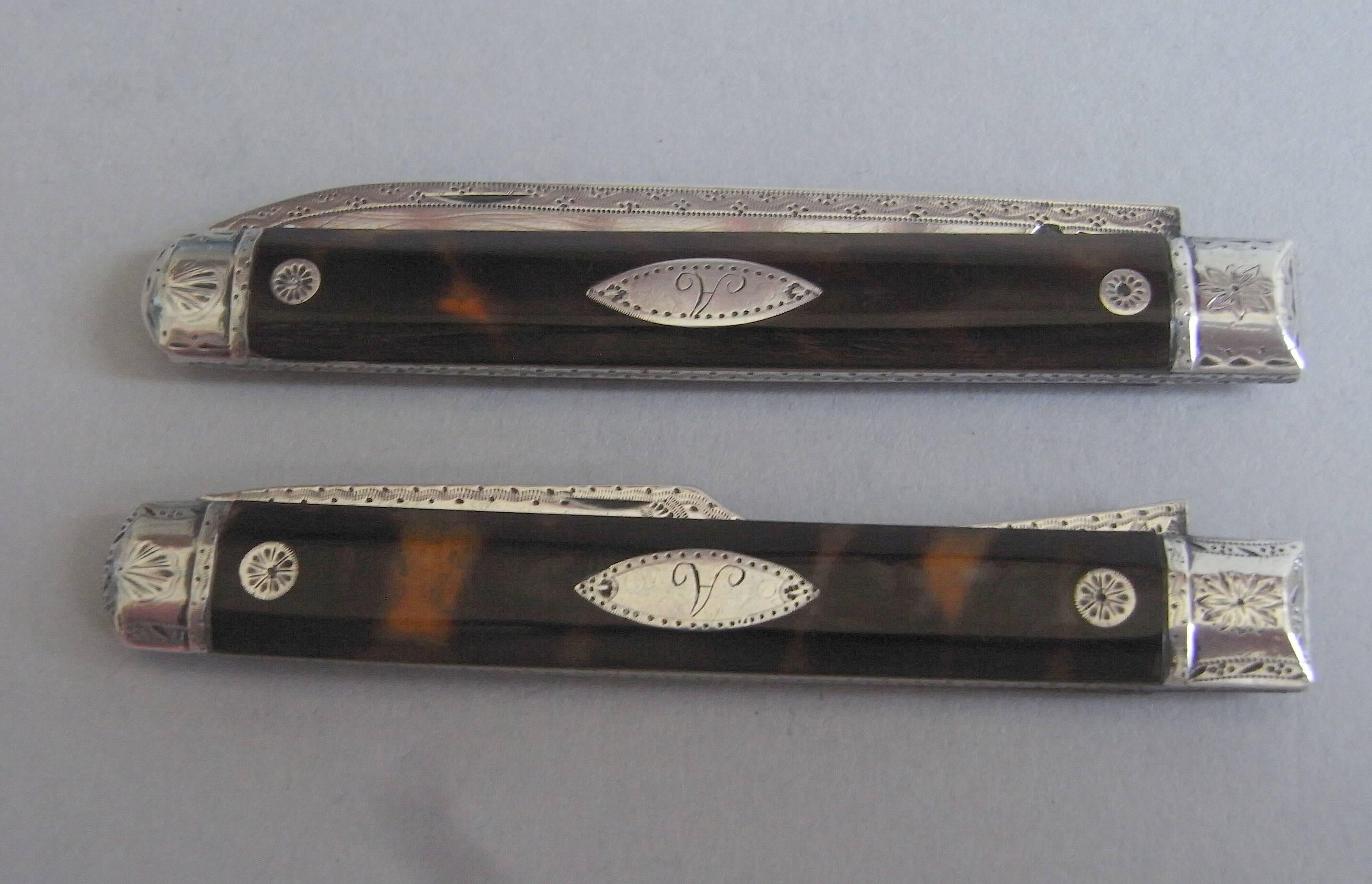 The blade of the knife and tines of the fork are decorated with crisp bright cut designs, as are the silver tops of the handles. The tortoiseshell panels are beautifully shaped and are inlaid with stylised flower heads and a navette shaped cartouche