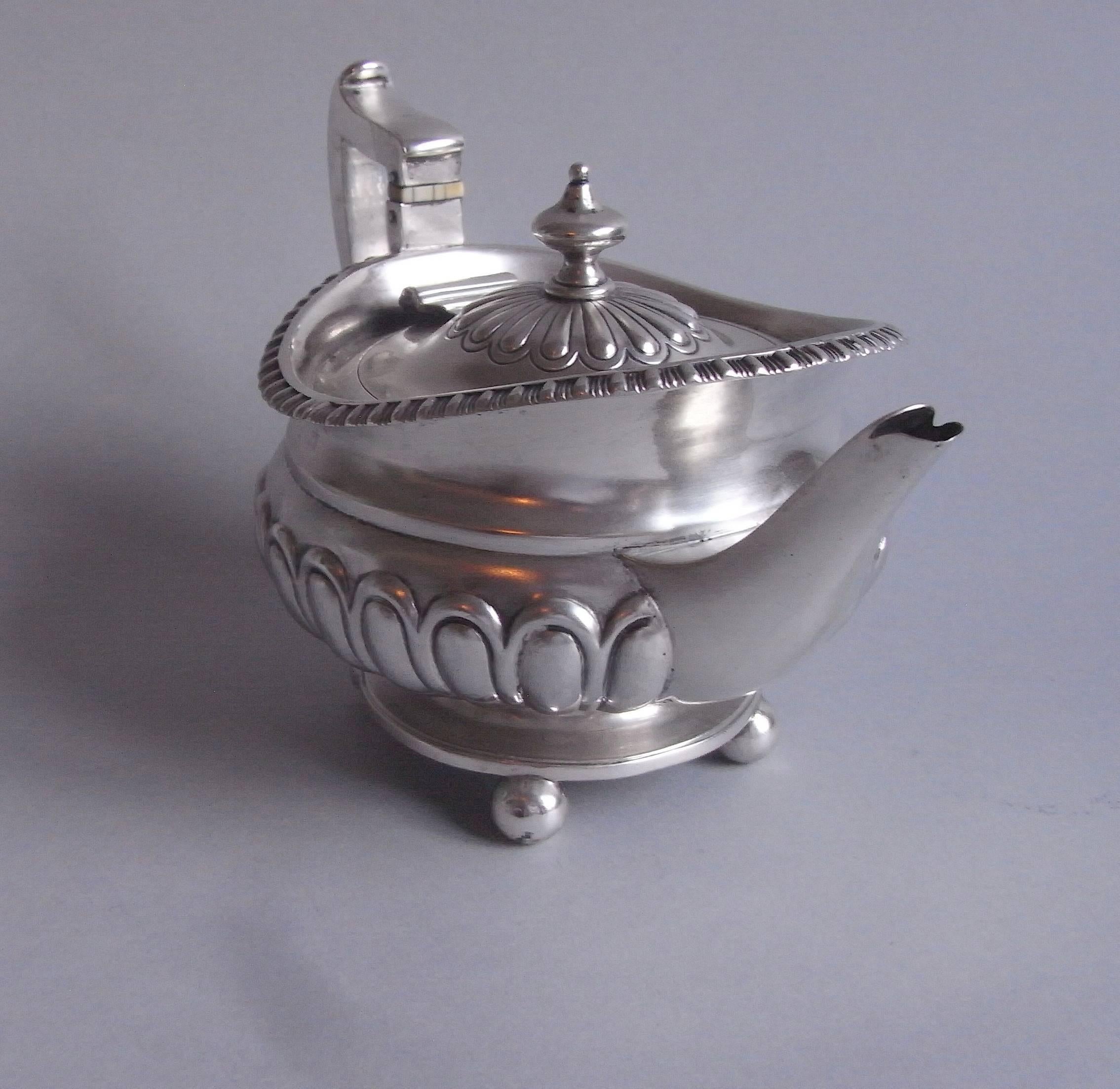 This attractive little pot has a circular platform base which stands on four ball feet. The baluster shaped main body is decorated with a wide lobed band which rises to an everted gadrooned rim. The design is without doubt a Scottish interpretation