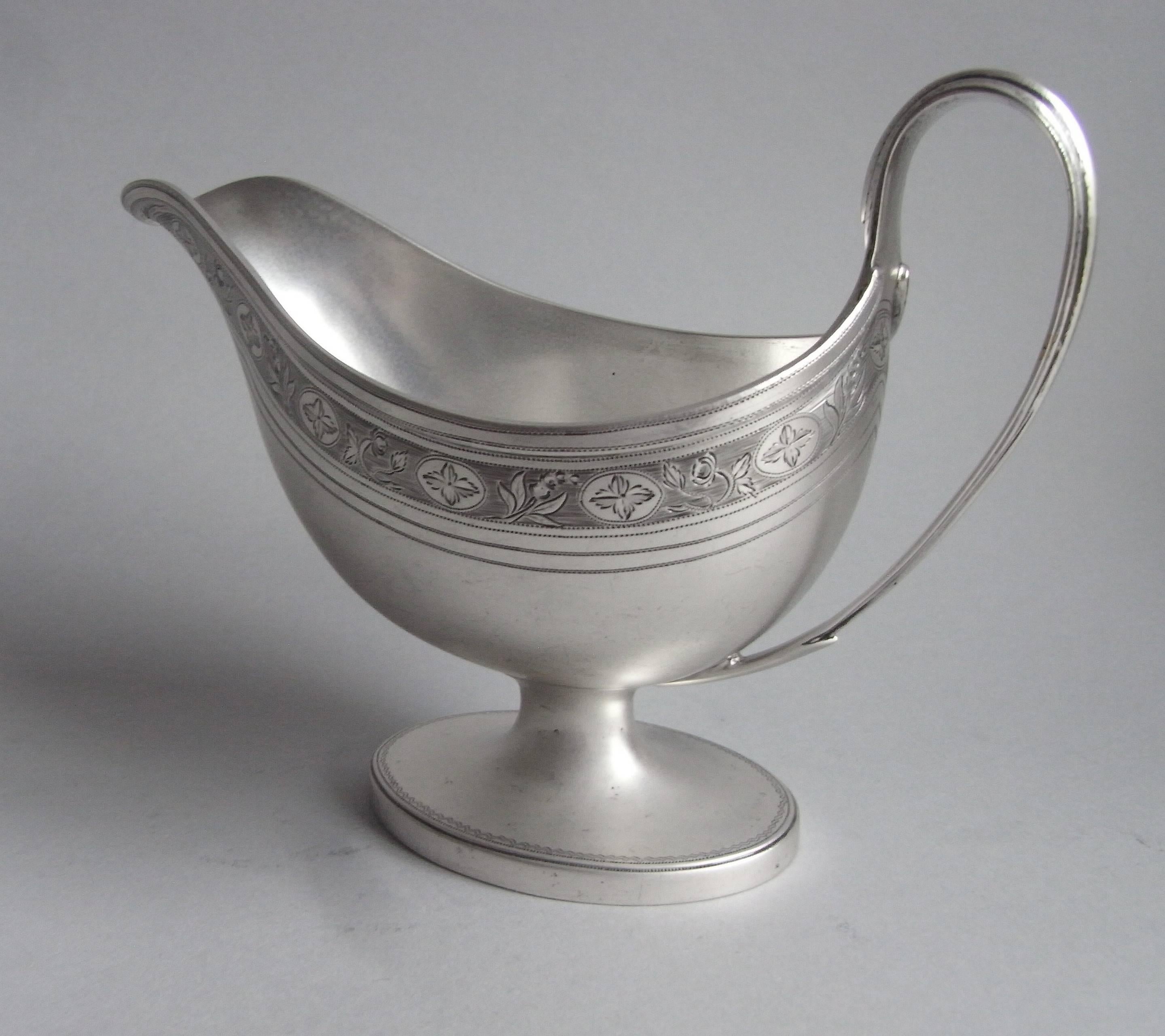 The Sauceboat stands on an oval collet foot engraved with an outer prick dot band. The main body is of a good size and has an everted prick dot rim. The upper section of the main body is also engraved with a beautiful band of foliate motifs and