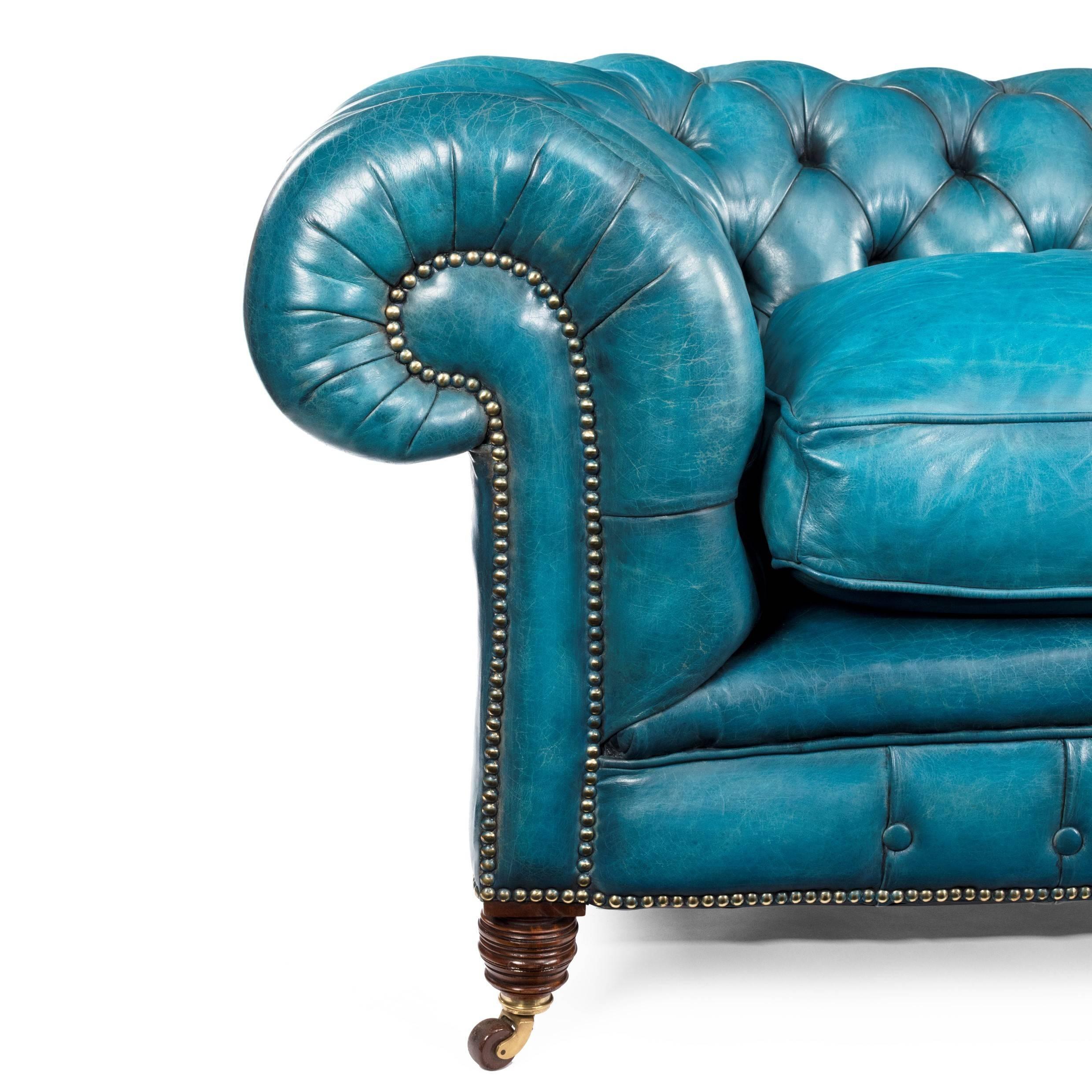 Late Victorian Chesterfield sofa with walnut legs, of typical form with deep seats and rolled arms and back, re-upholstered in deep buttoned turquoise leather.