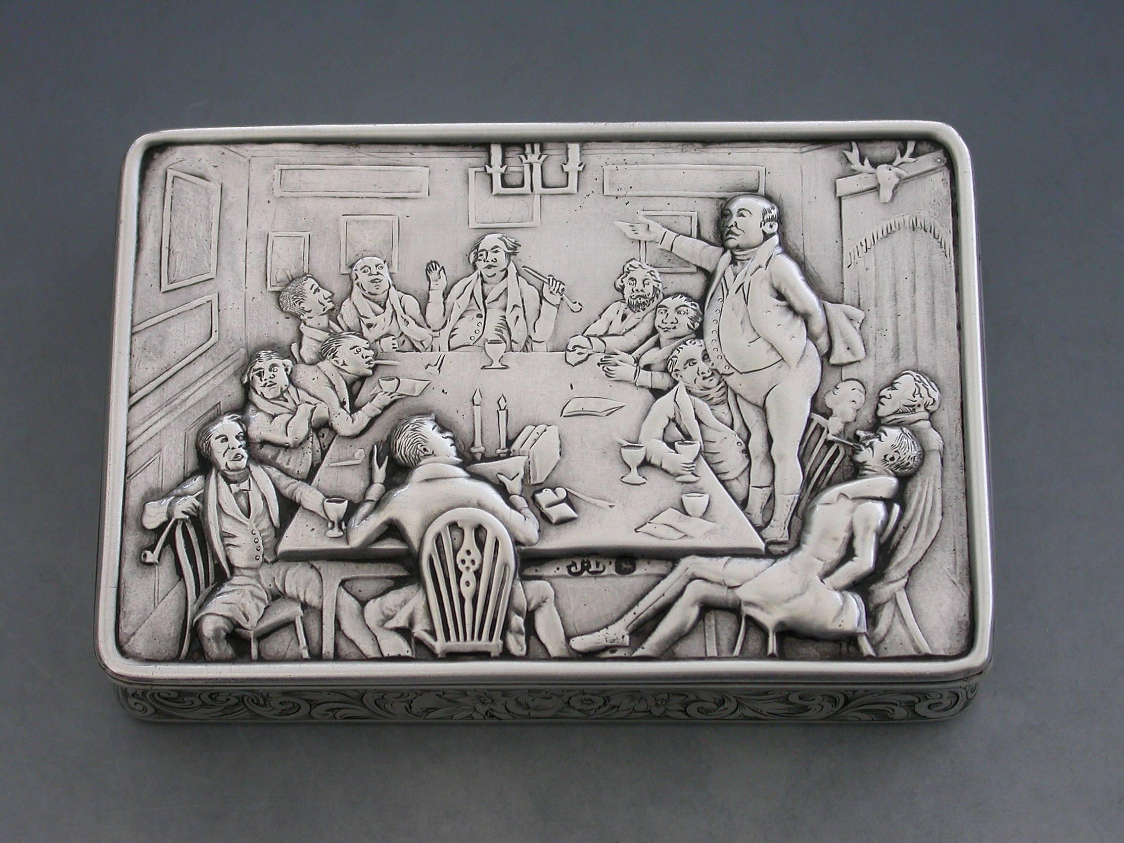 A rare Victorian silver snuff box of compressed rectangular form, the hinged cover chased with a scene from Charles Dickens' Pickwick Papers, depicting Mr Pickwick addressing the club (probably after the print by Seymour which formed the front-piece