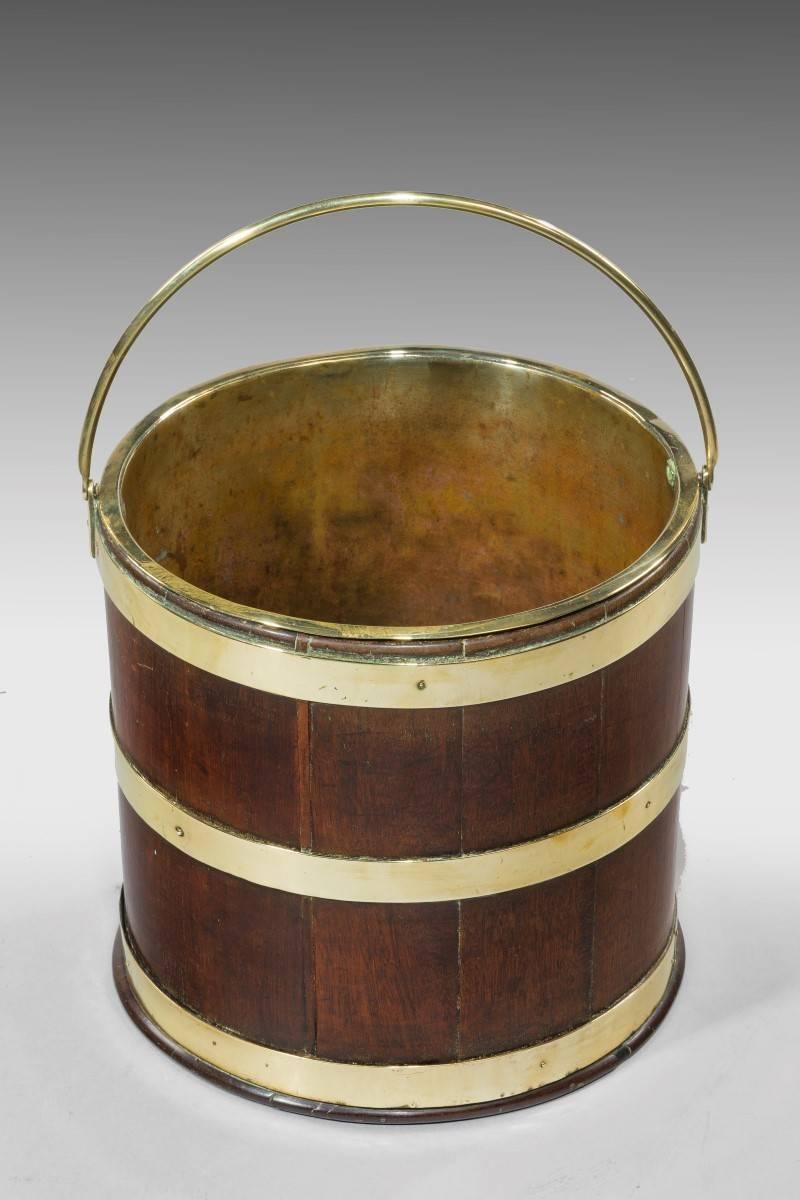 George III mahogany brass bound bucket with brass liner and swing handle. Ideal today as a planter.