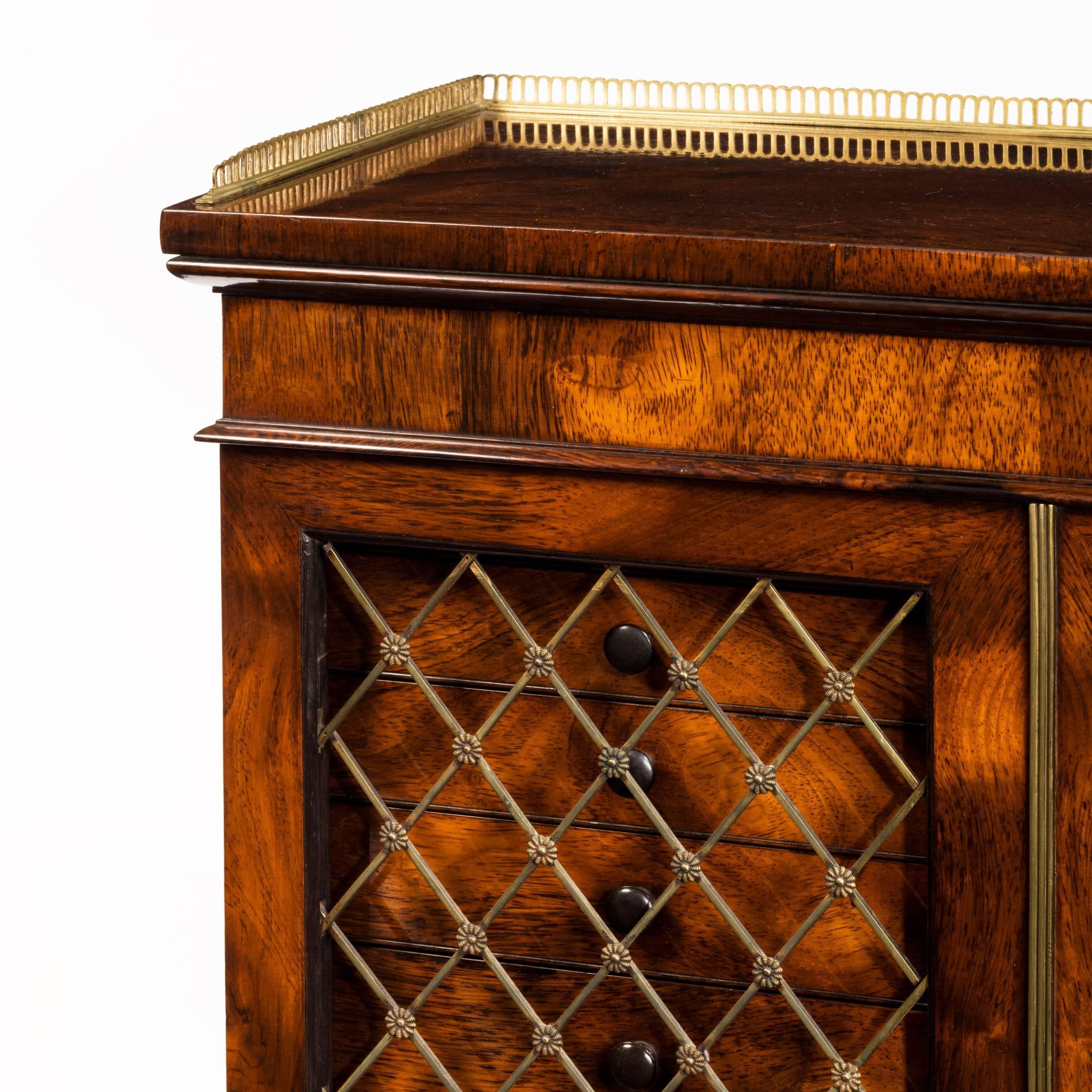 Late Regency collector's rosewood cabinet with two series of ten shallow drawers behind latticework grilles.