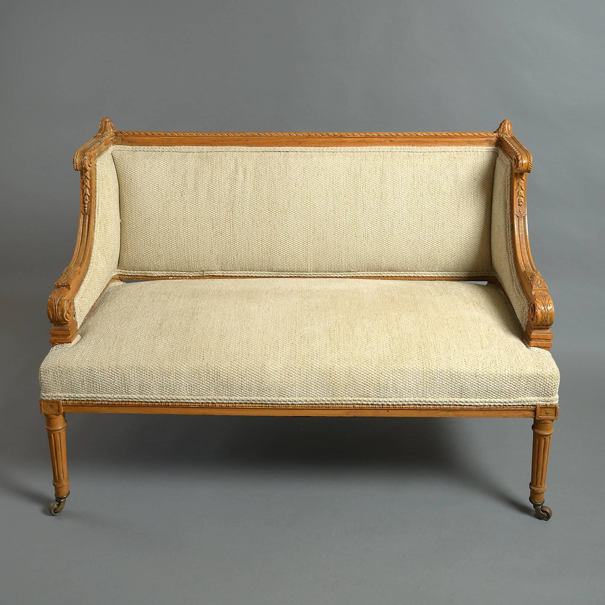 A finely carved late 19th century beechwood canapé sofa having wing arms and raised upon turned fluted tapering legs raised on the original brass casters.

A small sofa such as this would make an ideal addition to an intimate salon or a bedroom.