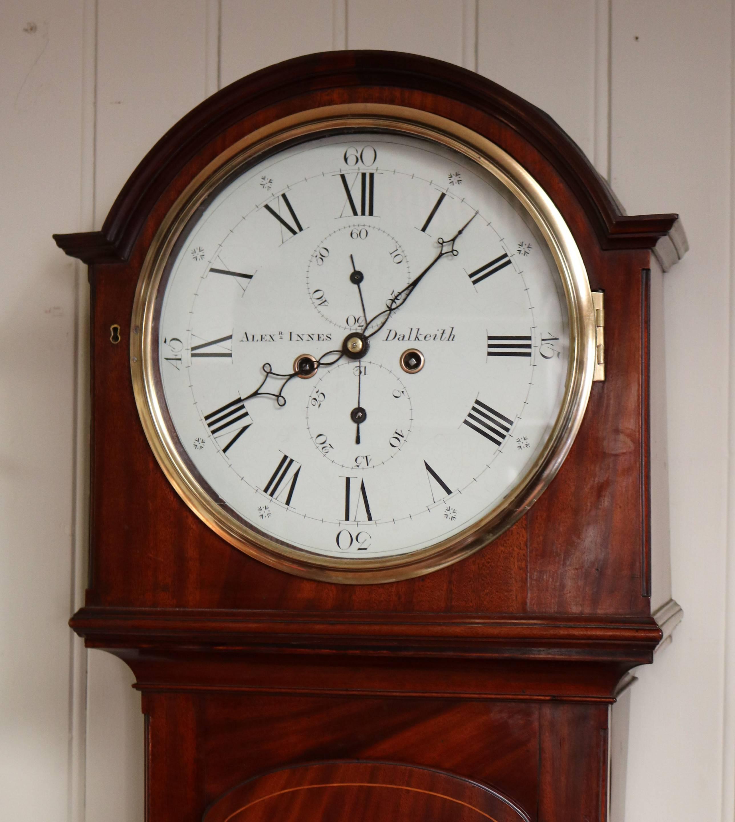 An early very original 19th century mahogany longcase clock of simple design. It has a dome top hood with a 13