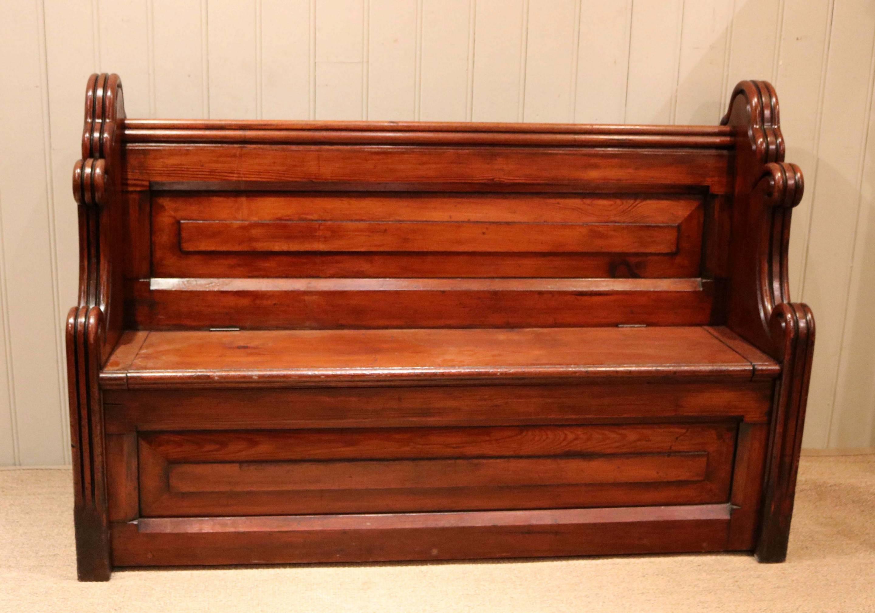Substantial pitch pine pew having an unusual rolling curved detailing with a box base. This pew was salvaged from a church in the Lancashire area.