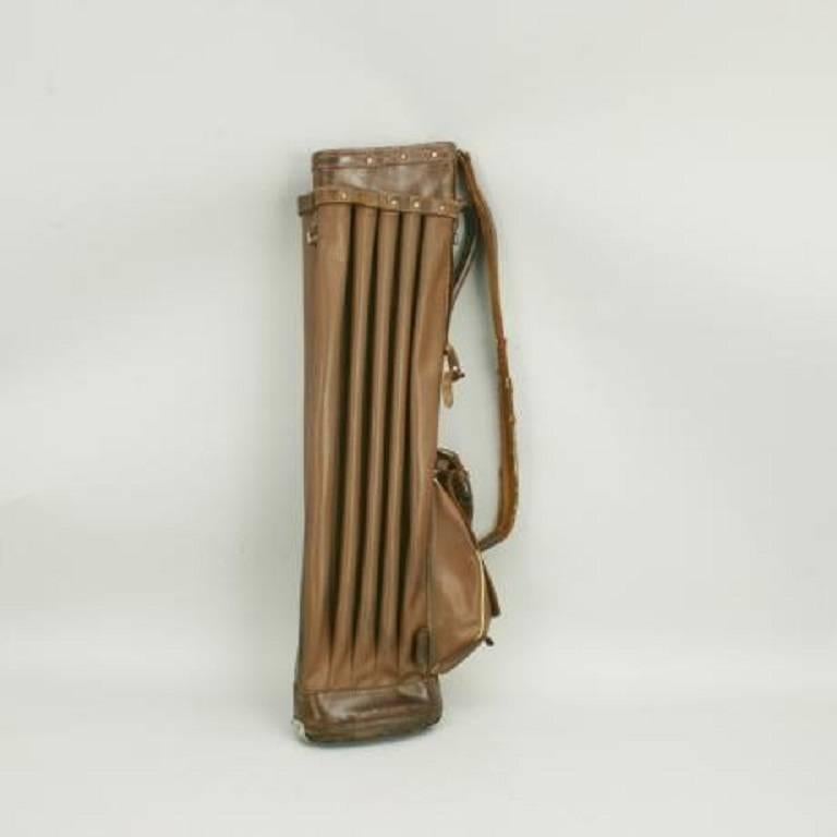 An unusual 1930s leather and rexine golf bag. The bag is with 14 individual dividers, four in the central panel and five on either side. The bag comes with one pocket for your golf balls and gloves etc., an adjustable shoulder strap, carry handle