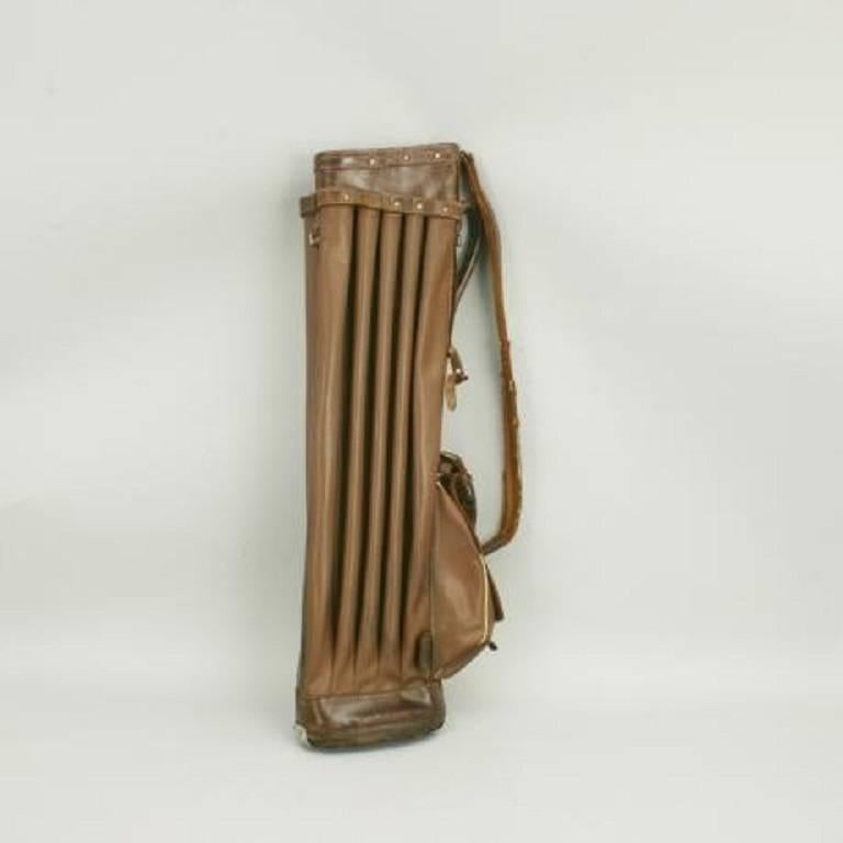An unusual 1930s leather and rexine golf bag. The bag is with 14 individual dividers, four in the central panel and five on either side. The bag comes with one pocket for your golf balls and gloves etc., an adjustable shoulder strap, carry handle