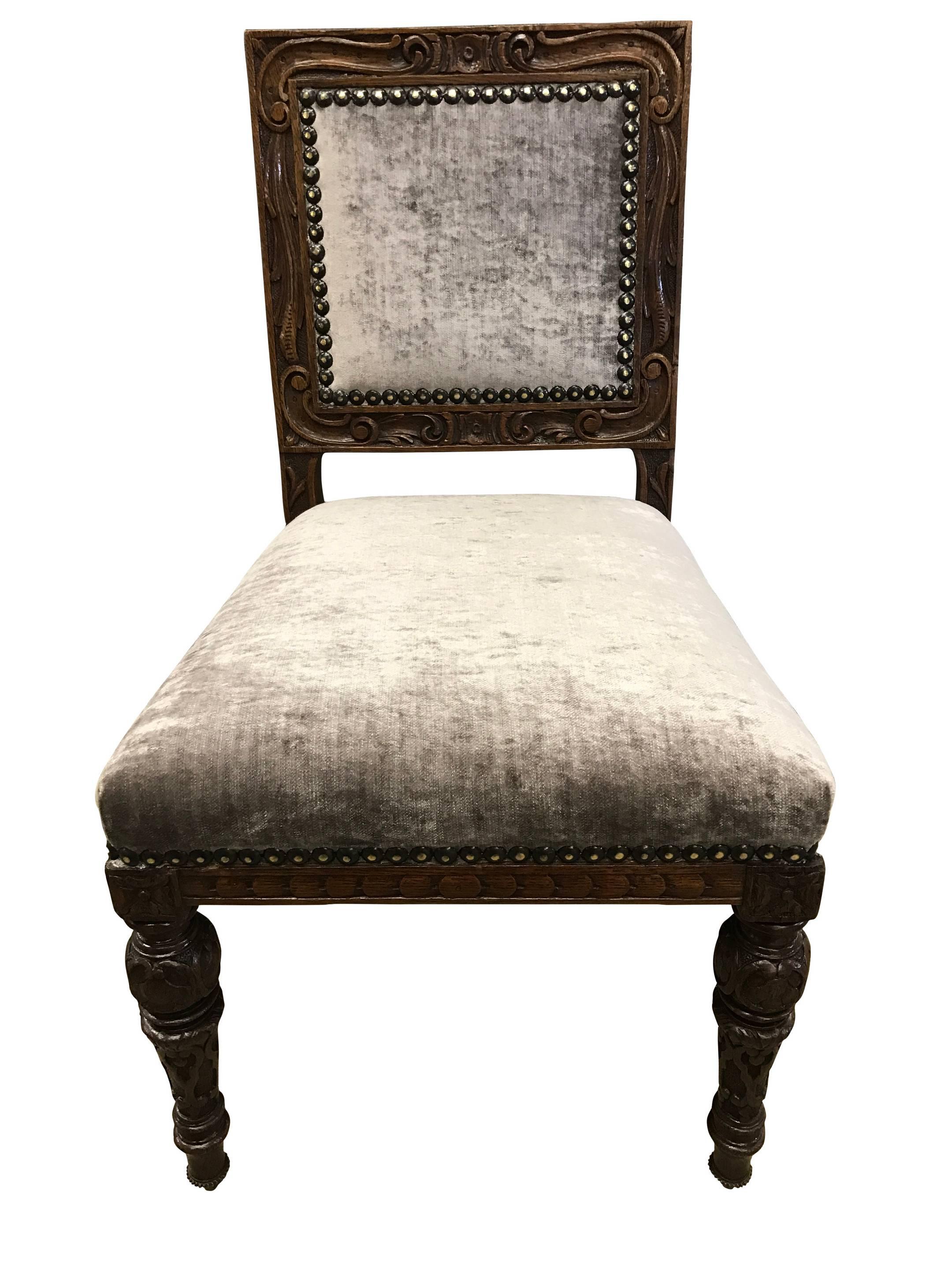 12 early Victorian oak dining chairs recently reupholstered in a very hard wearing mink velvet fabric. Attributed to Gillows of London and Lancaster, circa 1850. 

Dimensions: 
Height 35" 89cm 
Width 20" 51cm 
Depth 20.5" 52cm