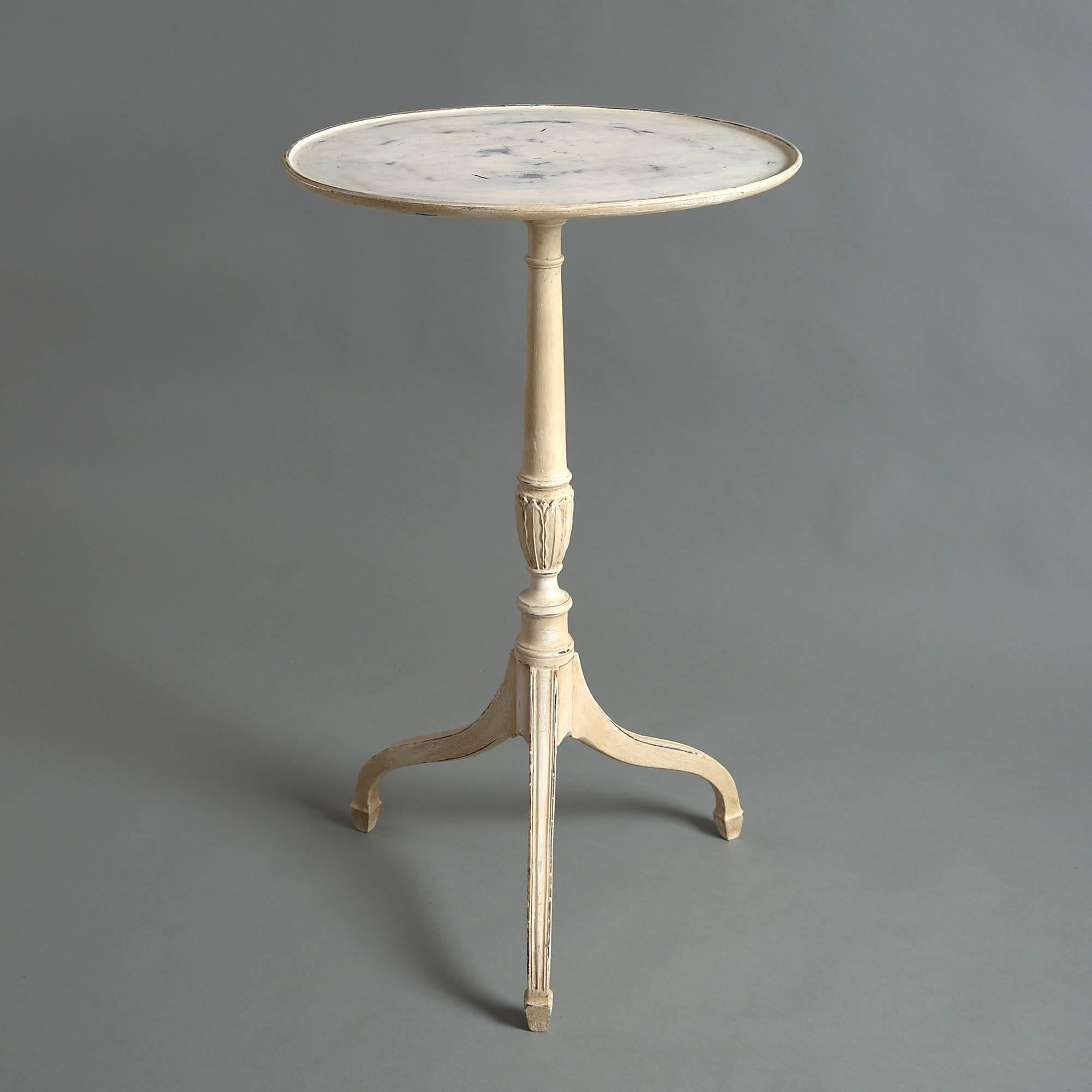 An early 20th century carved and painted occasional table with dish top, set upon a turned stem with carved palmettes and terminating in square tripod legs with spade feet.
   