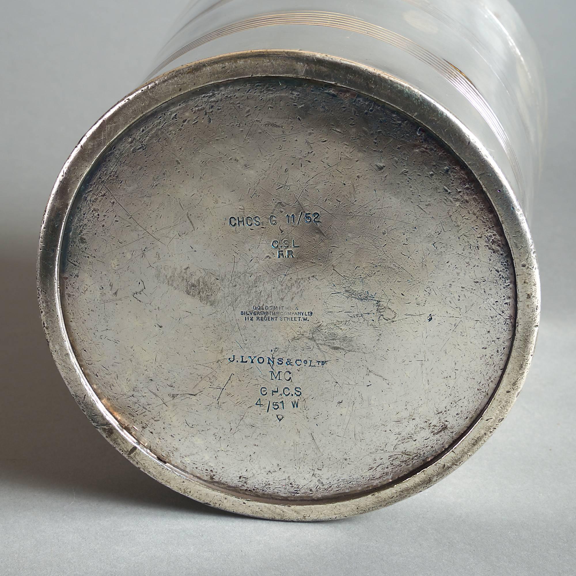 An early 20th century silver plated ice pail, the body with turned rings and having two carrying handles about the rim. 

With stamps for Lyons Corner Houses.