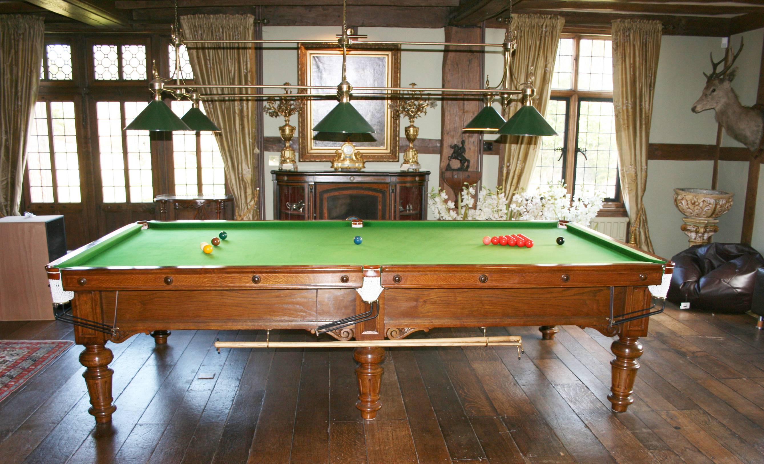 A very attractive ¾ size billiard table, snooker table originally manufactured by Burroughes & Watts. The table is made of oak and incorporates 6 good solid turned legs. The playing surface is a 4 piece slate bed covered in green playing cloth.