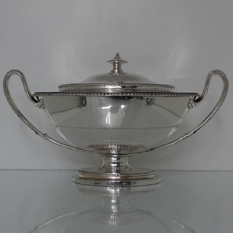 A very collectable heavy quality boat shaped silver soup tureen standing on a oval raised pedestal foot. The body of the tureen has half flute decoration with a upper band of gadroon decoration for highlights. The lid is detachable with an