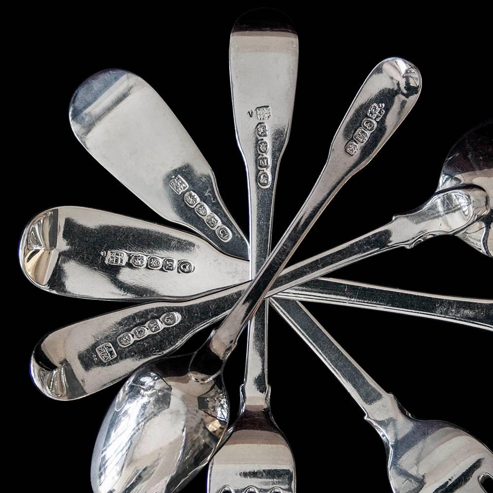 A Georgian antique silver fiddle pattern flatware for eight people including modern silver handled table and dessert knives. The forks and spoons all by William Eley, William Fearn and William Chawner. All hallmarked London 1807 except three