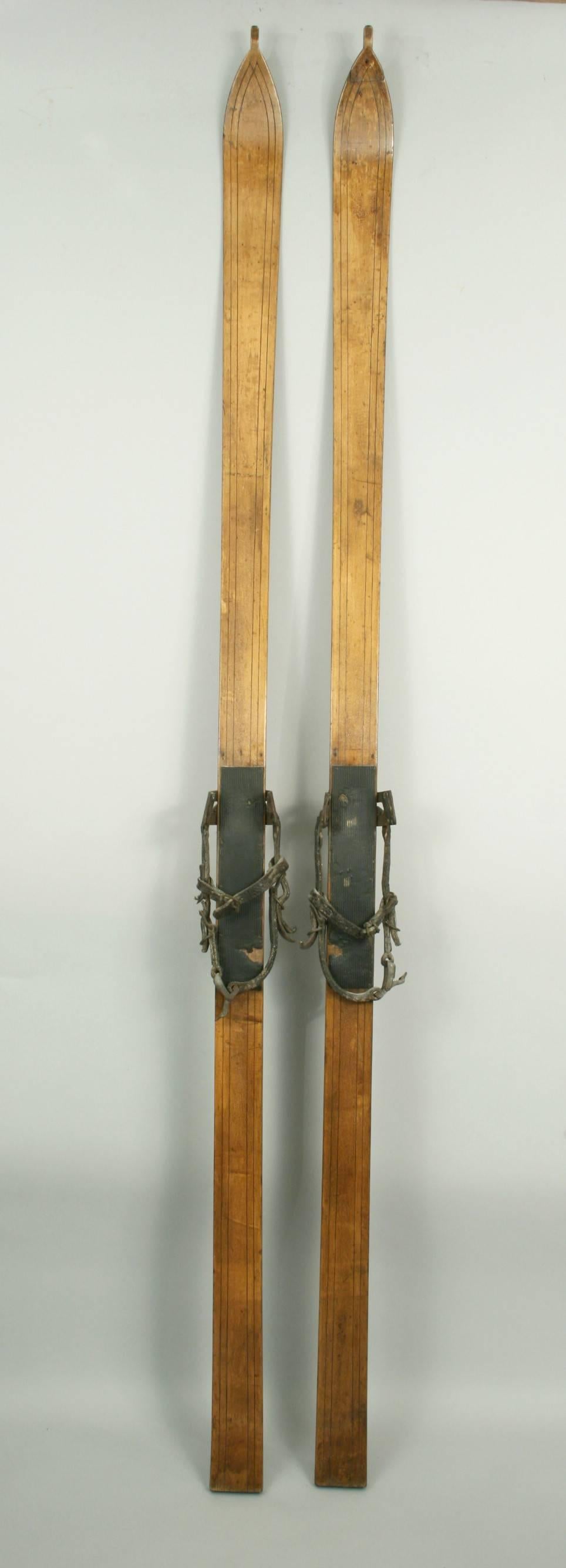 antique wooden skis with leather straps