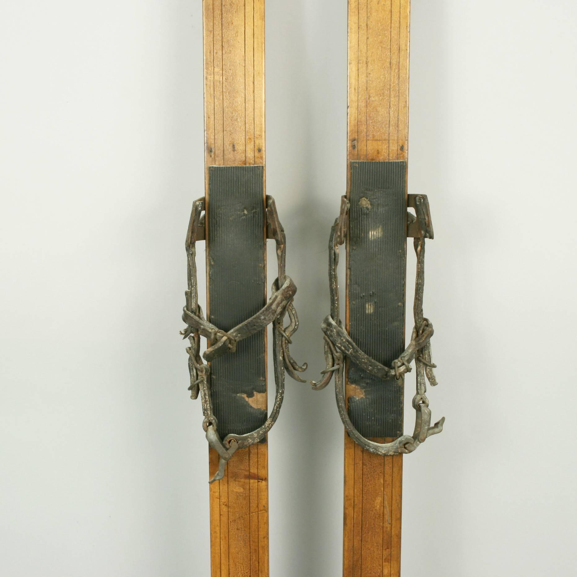 antique wooden skis with leather straps