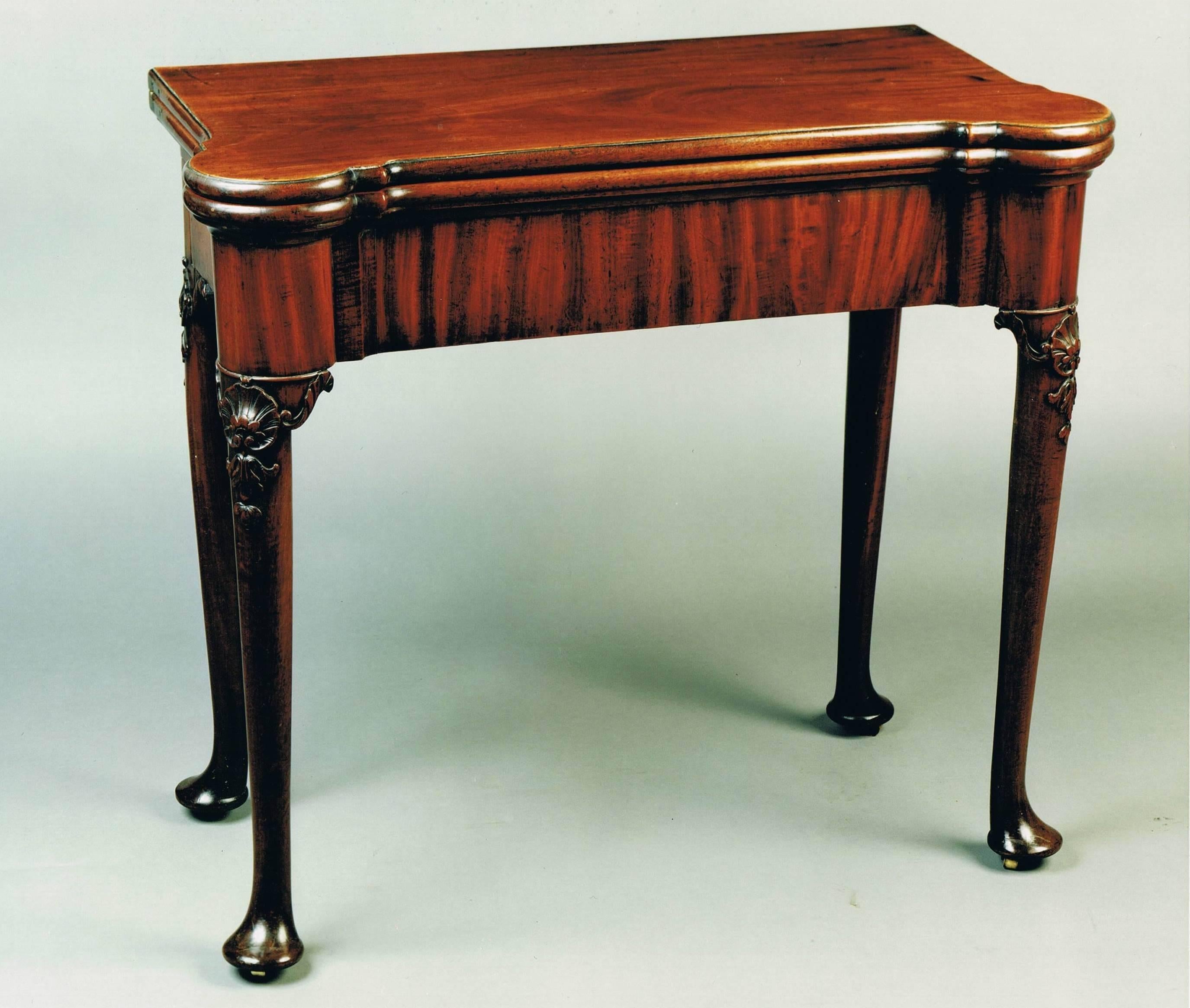 A fine and most elegant George II period two tier mahogany card table. The rounded rectangular top opens to reveal a baize, lined interior with guinea wells and places for candlesticks, there is also an unusual feature of a drawer. The second tier