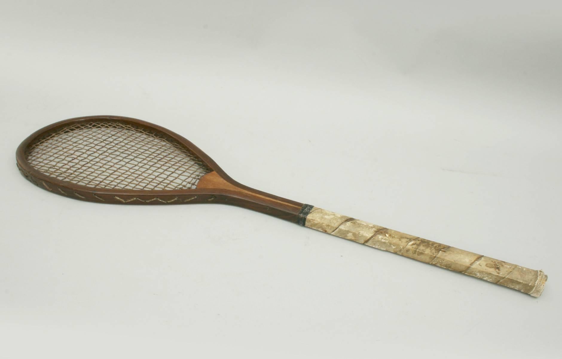Early lawn tennis racket.
This racket has all the signs of an early lawn tennis racket even though it is not a lopsided racket (tilt head). It is light and delicate like a Sphairistike racket, the stringing looks original and the handle has a white