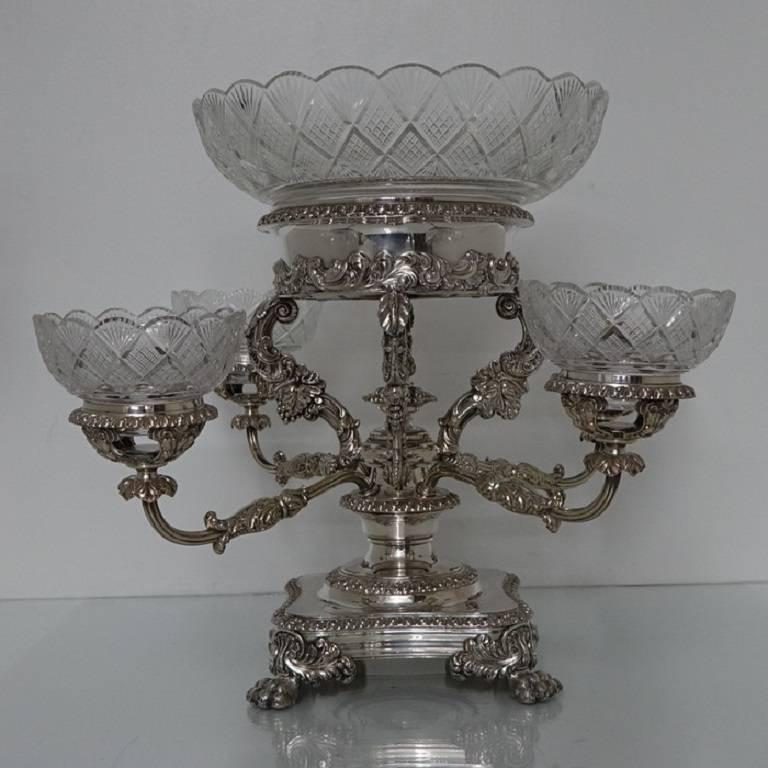A very elegant five bowl Old Sheffield epergne/centrepiece with original hand cut crystal bowls. The base has an ornate applied border for lowlights and sits on four stylish claw feet. The central column has decorative acanthus leaf and foliage