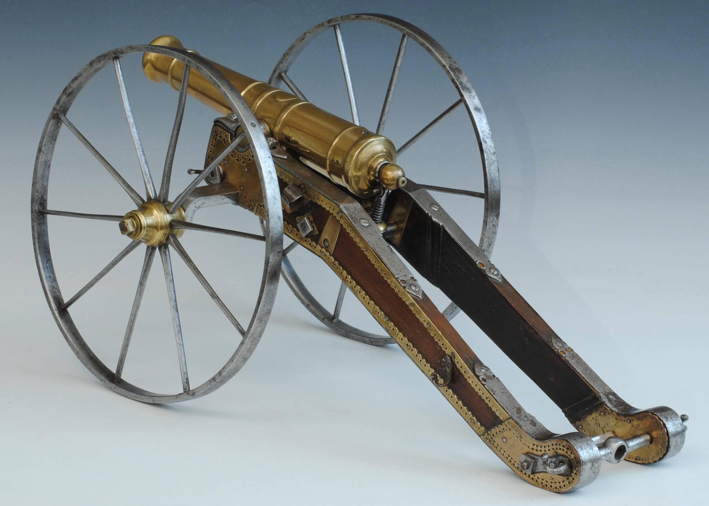 A fine brass barrelled cannon on a steel, brass and wood carriage, the barrel of four stage design.