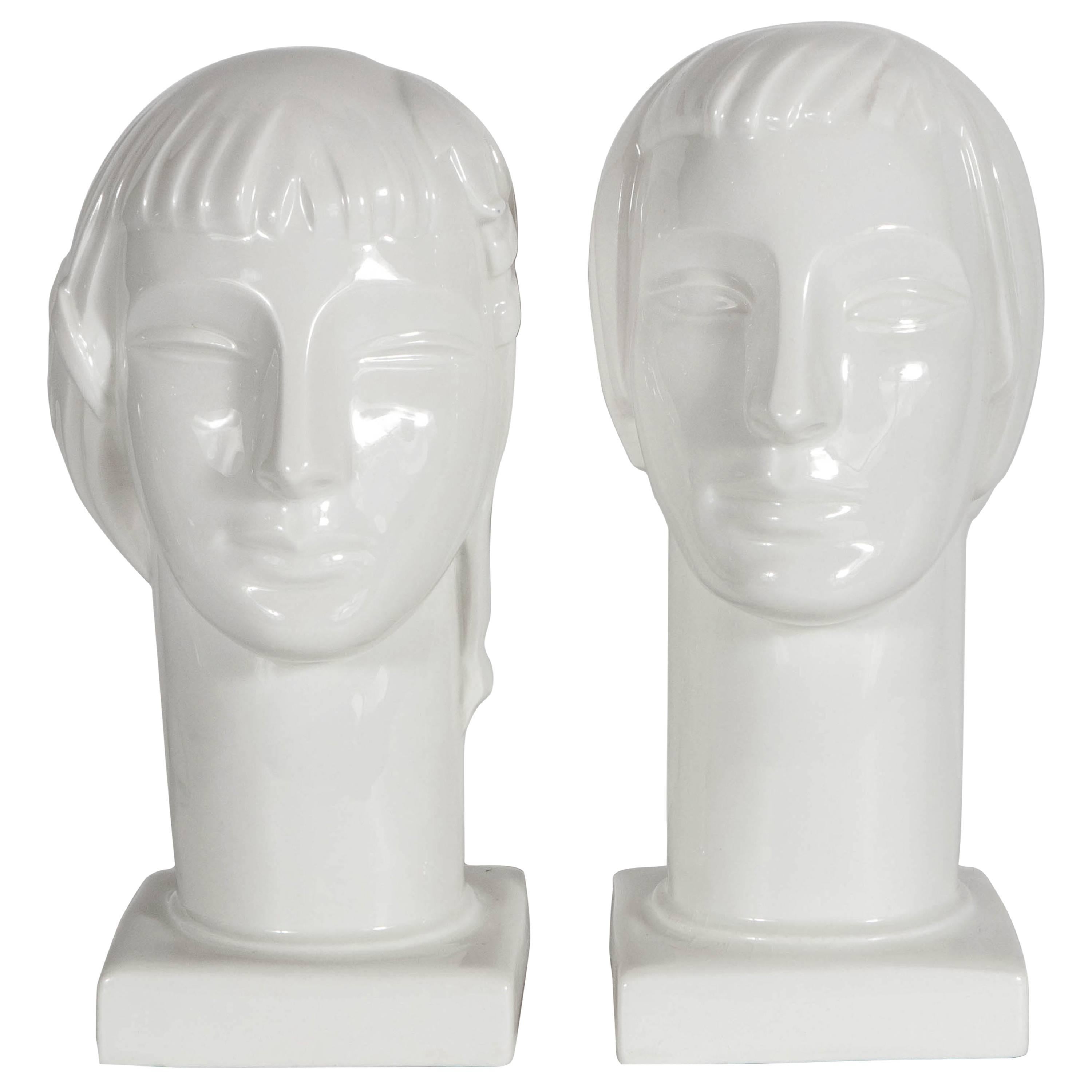 A truly gorgeous duo of male and female Art Deco figural heads sculptured by Geza De Vegh for Lamberton Scammell China Company. A glazed finish give this elegant pair of art pieces an elegant demeanor and serene facial expression. Both pieces are