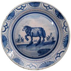 English blue and white delftware plate with image of a ewe in landscape c1725