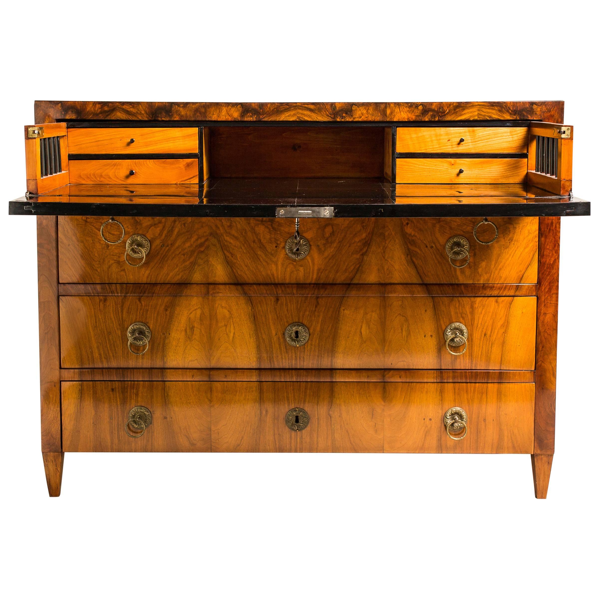 This outstanding Biedermeier conversion or writing desk has travelled through time from Austria in 1830 and is in search of the right home. The veneer with straight grained walnut is enhanced by the brass handles. Standing on firm legs constructed