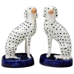Antique Pair of Staffordshire pottery figures of Dalmatians seated on blue bases