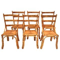 Set of six chairs in the style of Audoux-Minet, rattan, circa 1970, France.