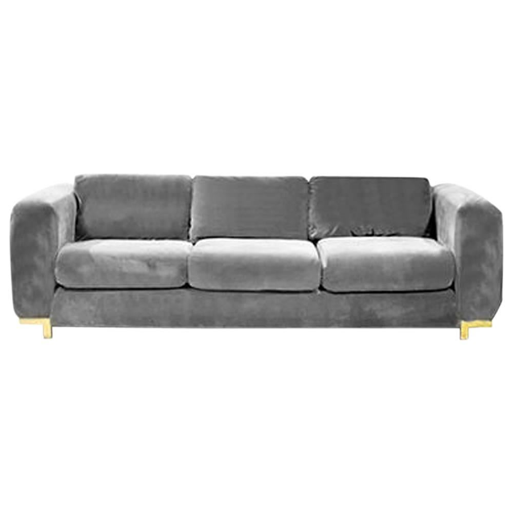 Three-seat grey velvet sofa newly upholstered on brass stretcher feet.