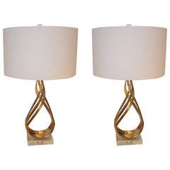 Striking Pair of Polished Twisted Bronze and Lucite Tall Sculpted Lamps