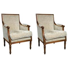 Pair of Louis XVI Style Bergère Chairs in a Walnut Frame Manner of Jansen