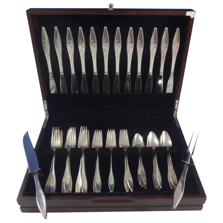 Star by Reed & Barton sterling silver flatware set of 50 pieces. This stunning Space Age Modernism pattern was designed by John Prip and introduced by Reed & Barton in the year 1960. This set includes:

12 knives, 9