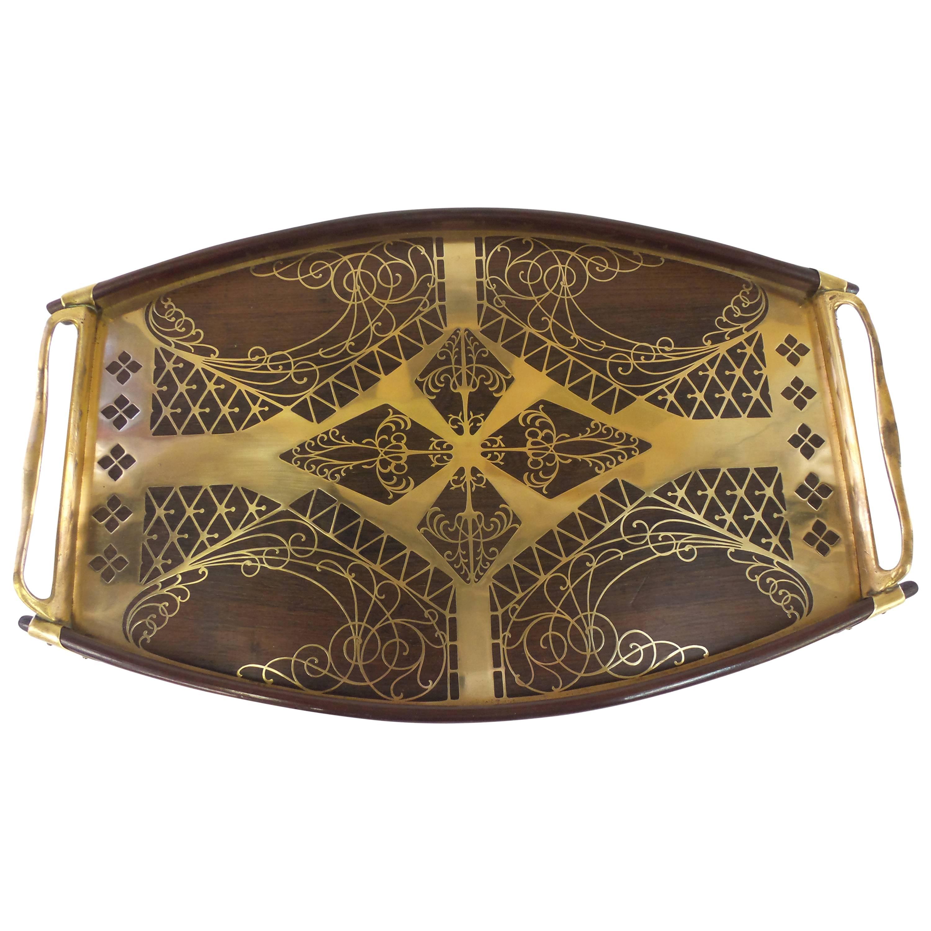 A Secessionist period tray with brass and rosewood geometric inlay on a mahogany and brass body. By Erhard & Sohne, Austria, circa 1905.