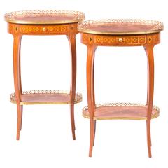 A pair of ormolu mounted rosewood and marquetry two-tiered side tables