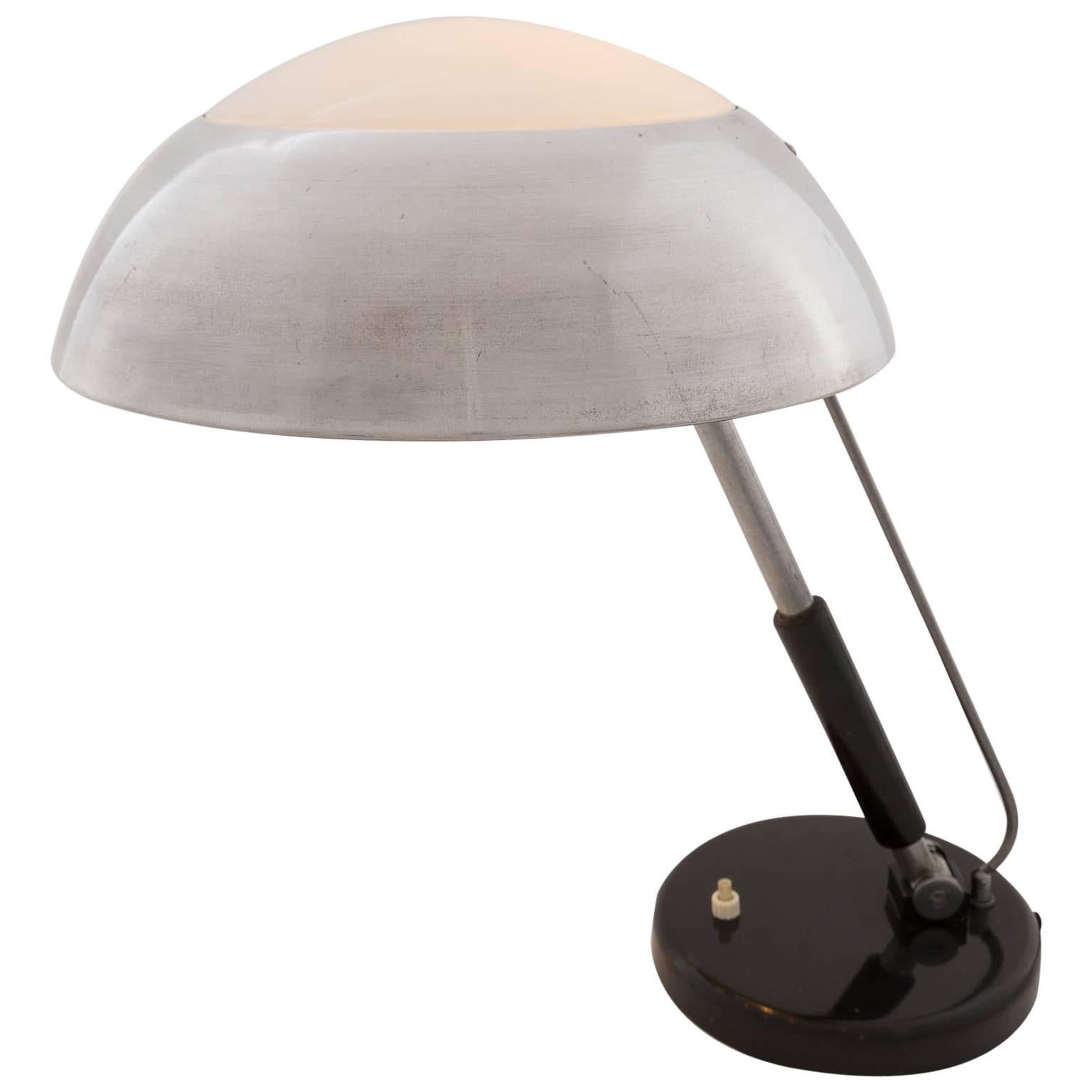 A table lamp designed by Karl Trabert for Schanzenbach, Germany, manufactured in circa 1930.
A polished nickel plated metal shade with an opal glass element in the centre. The stand is articulated and can be tilt forward or positioned