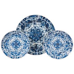 A Dutch Delft Blue and White Charger and a Matching Pair of Dishes